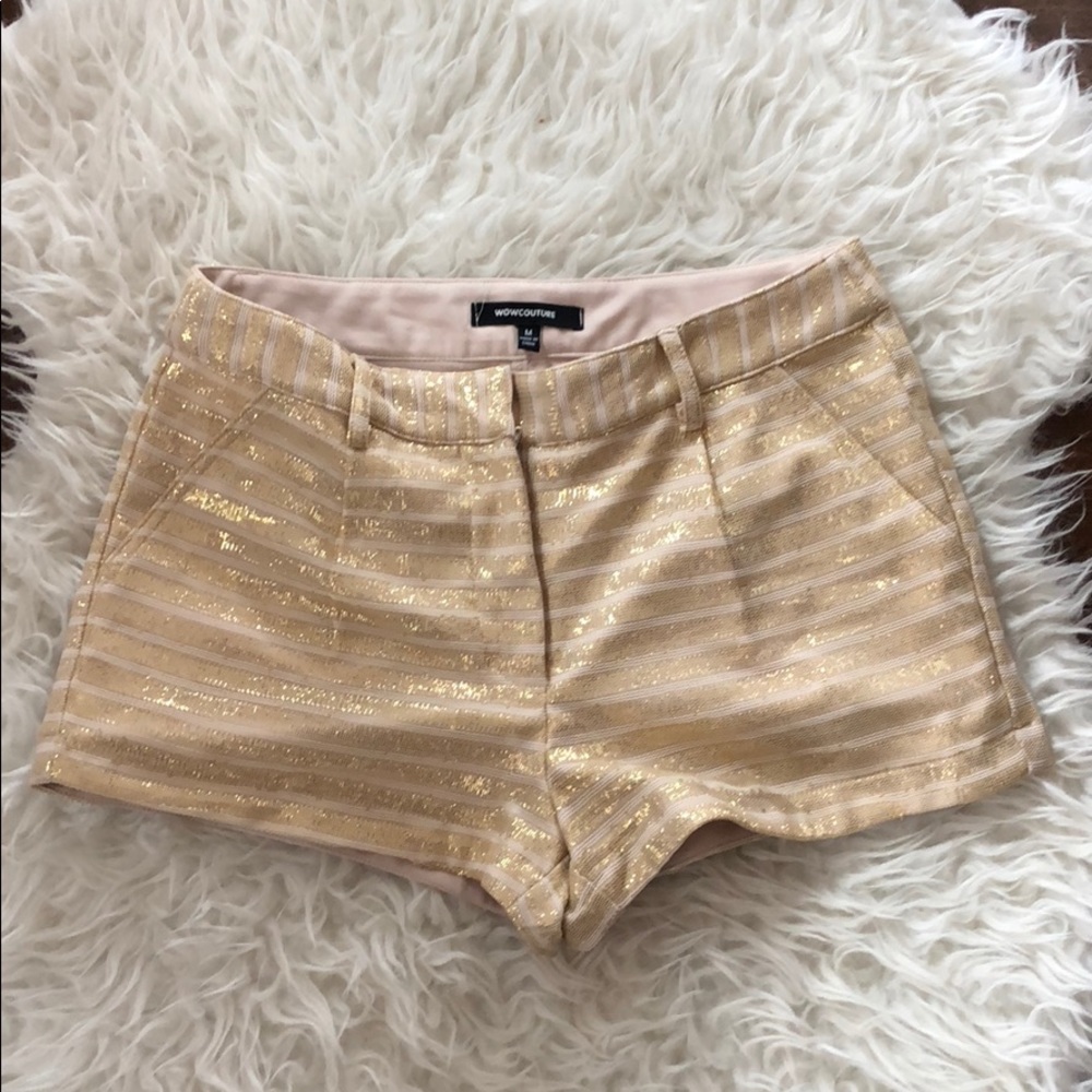 Shiny gold striped shorts.